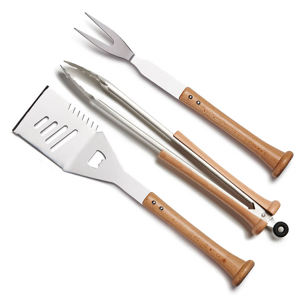 Three-piece grill tool combo with bat-handle spatula, tongs, and fork arranged on a clean white background showing all stainless heads