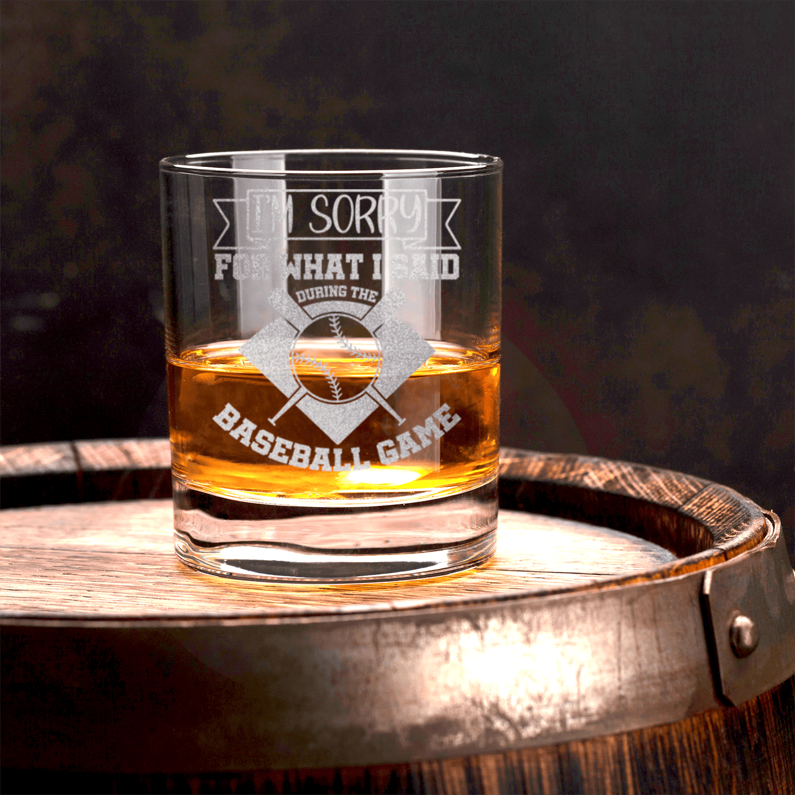 Whiskey rocks glass etched with the 'I'm Sorry For What I Said During The Baseball Game' saying and a crossed-bats baseball graphic, shown empty on a clean background